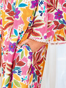 Close-up of the floral dress side pocket and lace-trim sleeve cuff