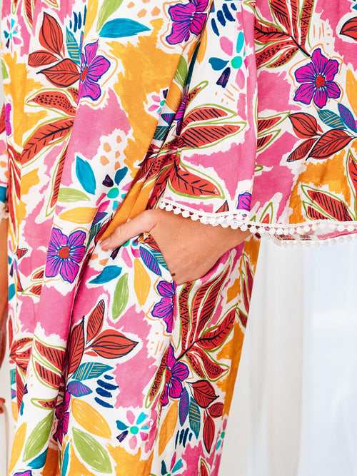 Close-up of the floral dress side pocket and lace-trim sleeve cuff