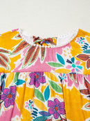 Close-up of the floral dress front neckline and gathered yoke