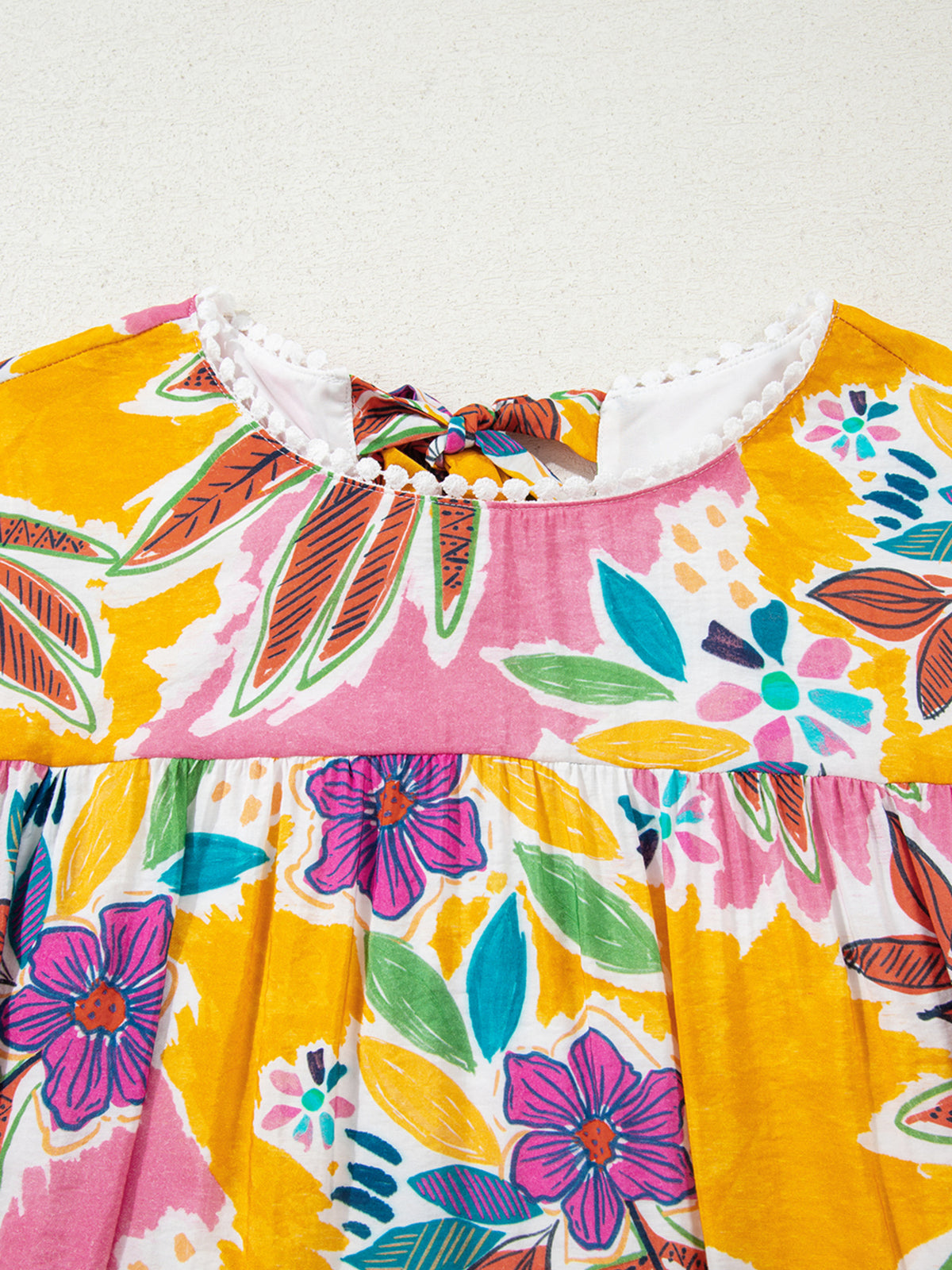 Close-up of the floral dress front neckline and gathered yoke