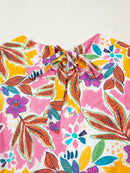 Close-up of the floral dress back neckline with bow and keyhole