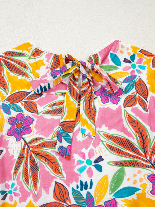 Close-up of the floral dress back neckline with bow and keyhole