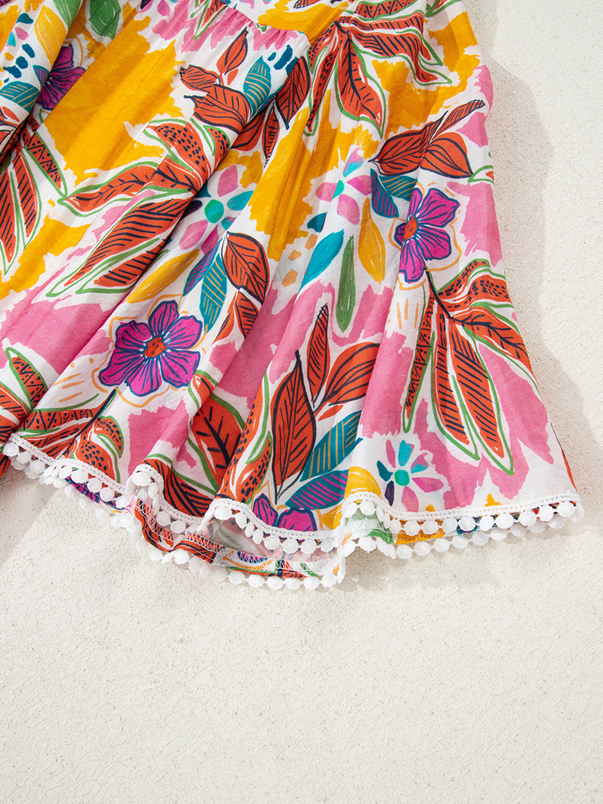 Close-up of the floral bell sleeve and white lace-trim cuff