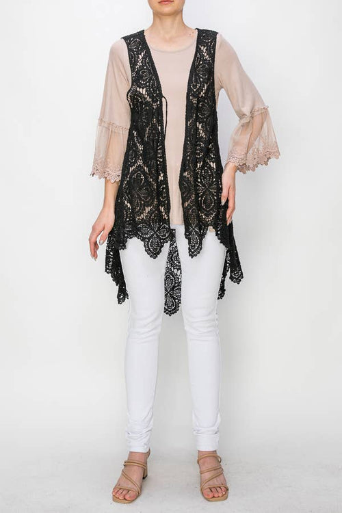 Angled front view of the Origami black crochet vest layered over a beige blouse