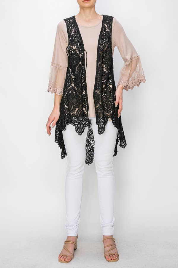 Angled front view of the Origami black crochet vest layered over a beige blouse