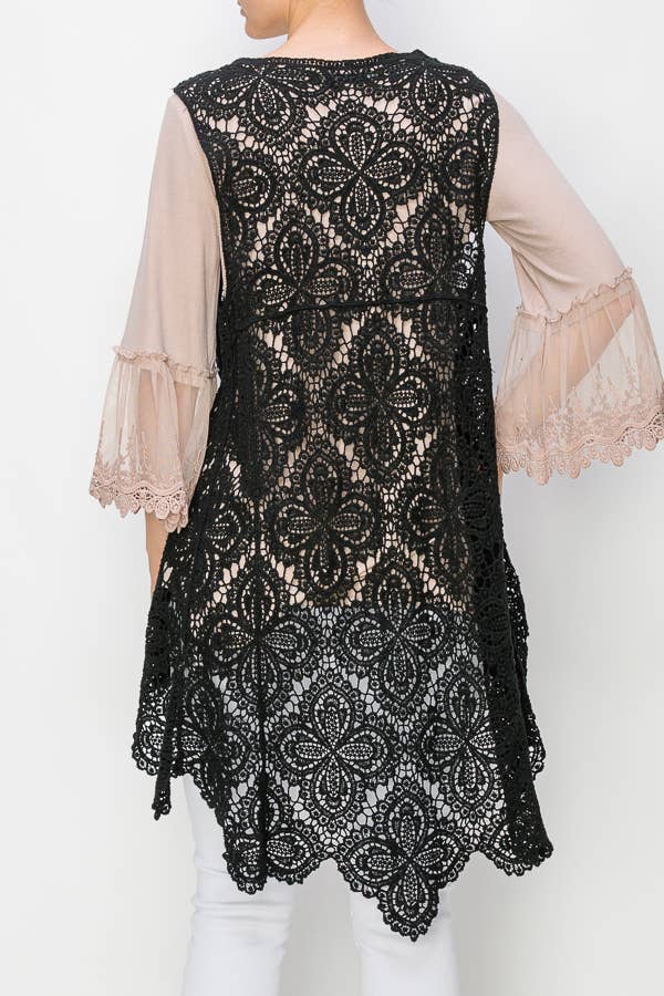 Back view of the Origami black crochet vest showing the floral openwork pattern and scalloped hem