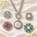 Sandy Snap Stainless Steel Interchangeable Jewelry Toggle Necklace plain base beside four separate decorative snaps; styling choices
