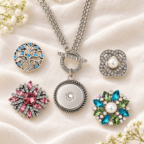 Sandy Snap Stainless Steel Interchangeable Jewelry Toggle Necklace plain base beside four separate decorative snaps; styling choices