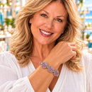 Styling photo of a woman in a white blouse wearing a bracelet with pink and purple snap charms