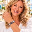 Styling photo of a woman in a white blouse wearing a bracelet with multicolored snap charms