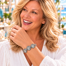 Styling photo of a woman in a white blouse wearing a bracelet with silver snap charms