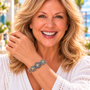 Styling photo of a woman in a white blouse wearing a bracelet with bronze snap charms