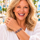 Styling photo of a woman in a white blouse wearing a bracelet with pink snap charms
