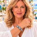 Styling photo of a woman in a white blouse wearing a bracelet with white and black snap charms