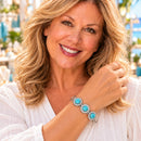 Styling photo of a woman in a white blouse wearing a bracelet with turquoise and clear snap charms