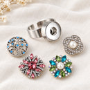 Stainless Steel Sandy Snap Interchangeable Charm Ring plain base beside four separate decorative snaps; styling choices