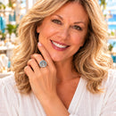 Woman wearing a silver-tone ring with a purple snap charm