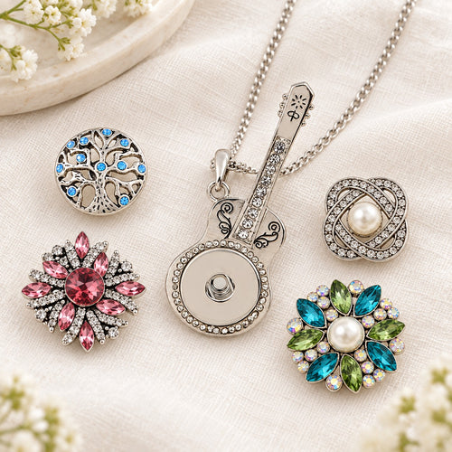 Silver Guitar Sandy Snap Interchangeable Charm Necklace plain base beside four separate decorative snaps; styling choices