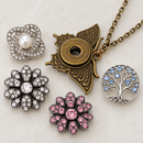 Plain bronze butterfly Sandy Snap necklace with empty socket beside four interchangeable snap charm styling options