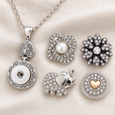 Empty silver circle and vintage heart snap necklace beside pearl, crystal flower, elephant and gold-heart snap choices