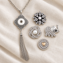 Empty filigree tassel necklace beside four snap choices