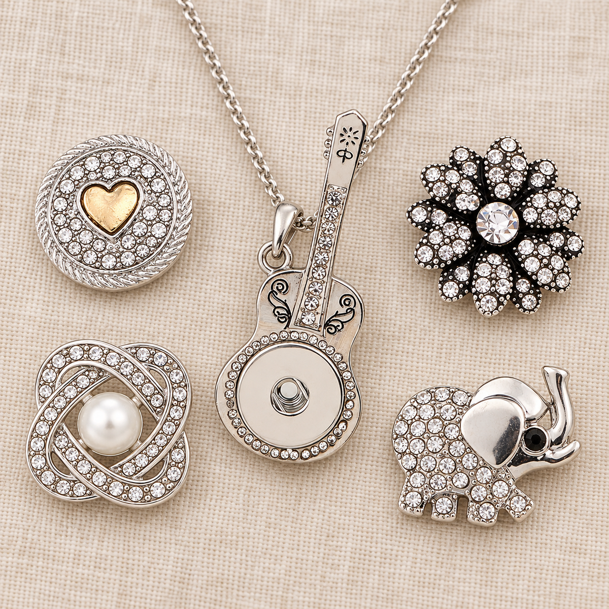 Empty silver guitar necklace beside four snap choices