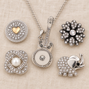 Empty silver guitar necklace beside four snap choices