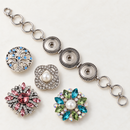 Plain silver three-snap bracelet beside four loose decorative snaps; styling choices shown