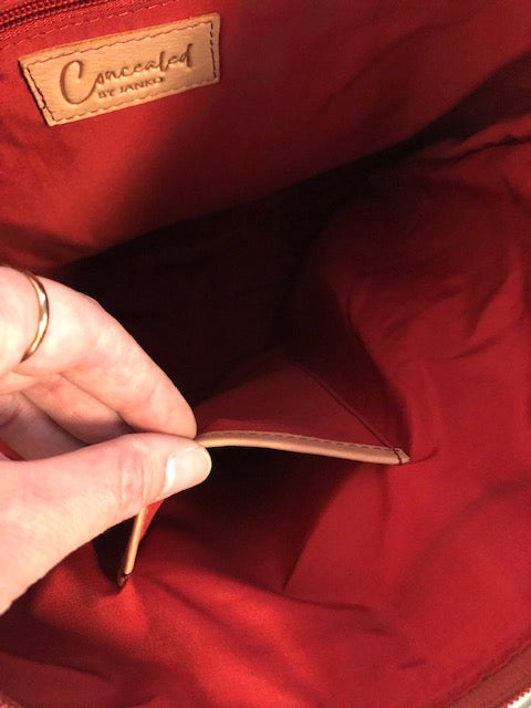 Interior slip pocket in the red-lined Janko Ruth Wine handbag