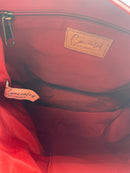 Interior of the Janko Ruth Wine handbag showing its red lining and pockets