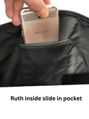 Interior slip pocket in the black Janko Ruth handbag, shown holding a phone