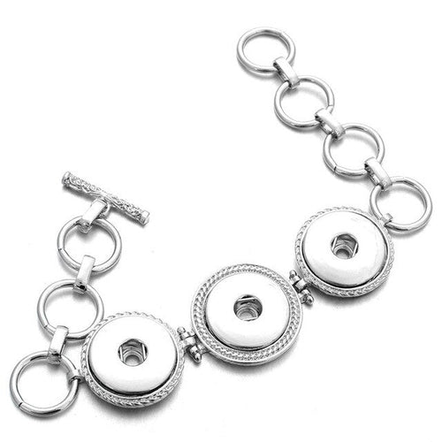 Silver-tone three-snap bracelet with linked rings and toggle closure