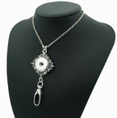 Silver-tone Sandy Snap lanyard necklace with a floral snap setting and badge clip on a black display bust